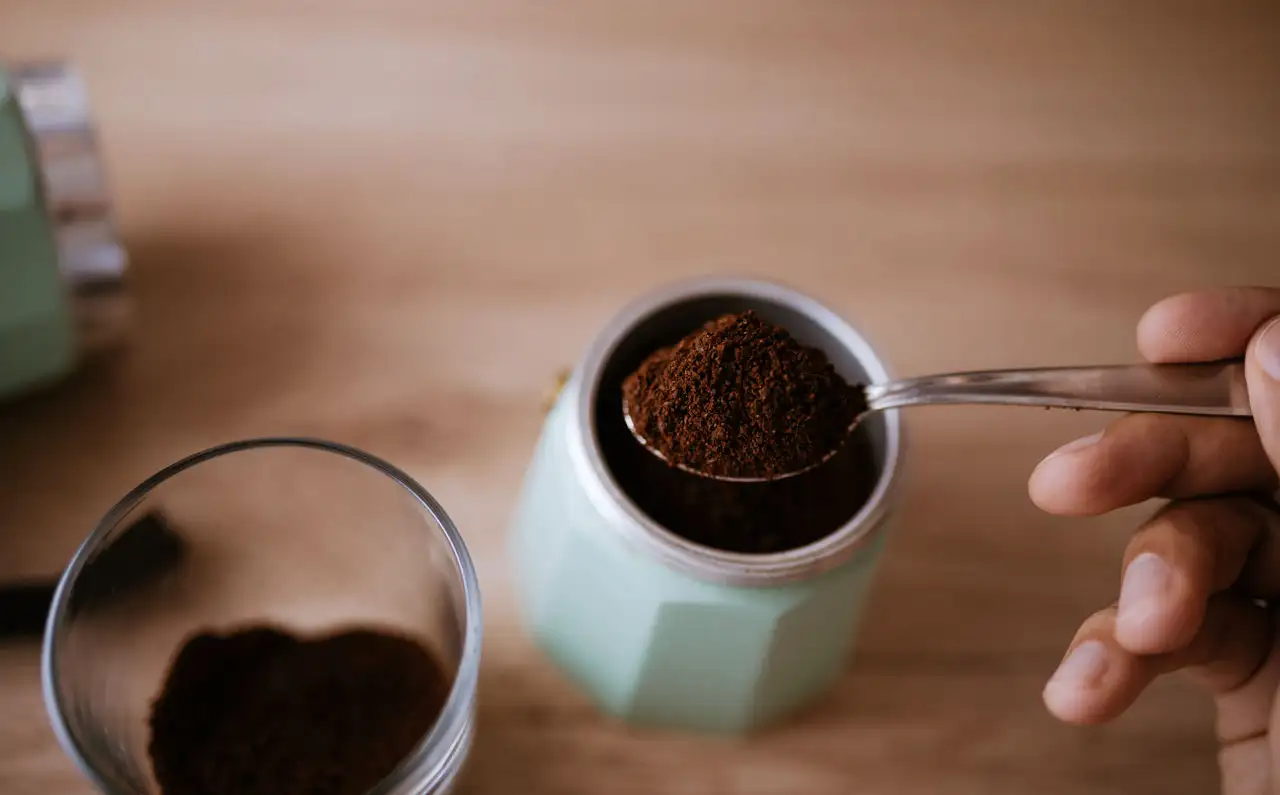 Coffee being spooned into Caffettiera