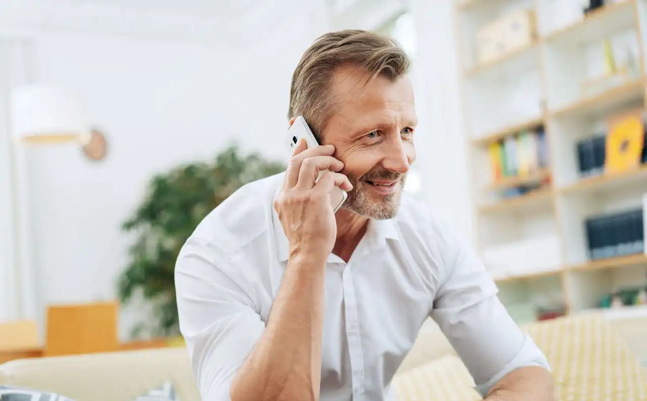 Person sitting on a couch having a phone conversation