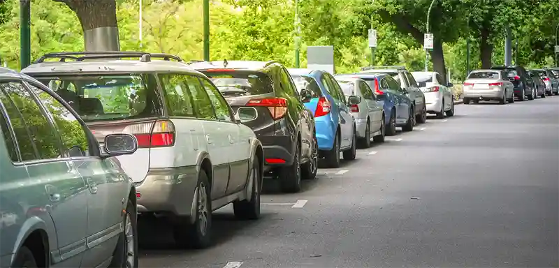 Cars parallel parked on the side of a street