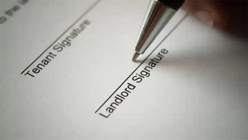 A pen ready to sign a contract on the Landlord signature line