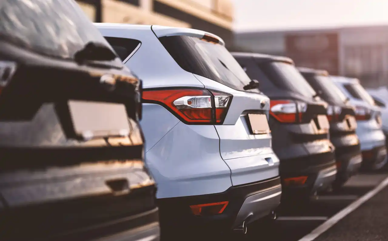 Black and white cars parked neatly in a parking lot